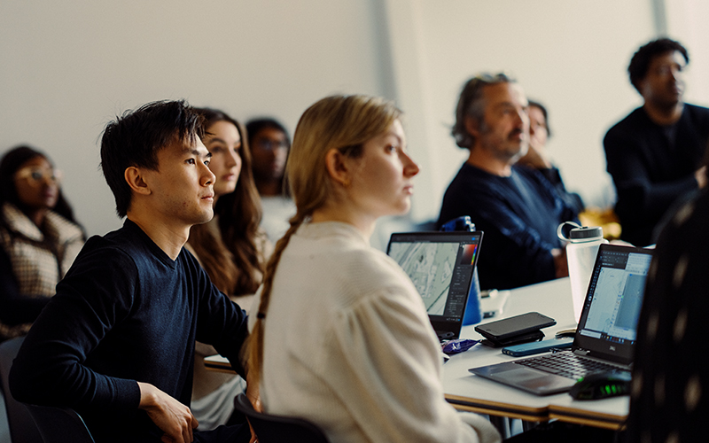 Two students paying close attention in a lecture