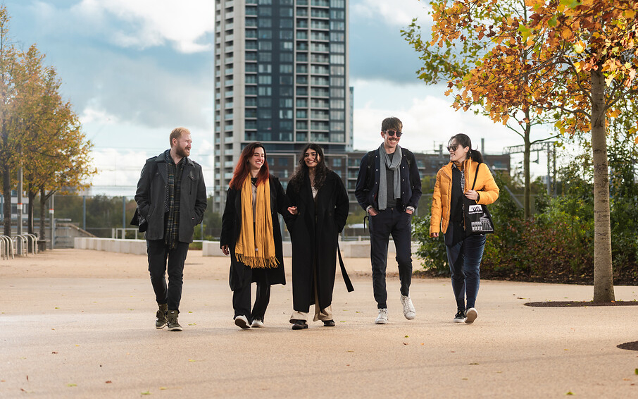 Photo of students walking together through an urban park