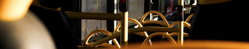 London bus seats catching the sun on their distinctive yellow handles.