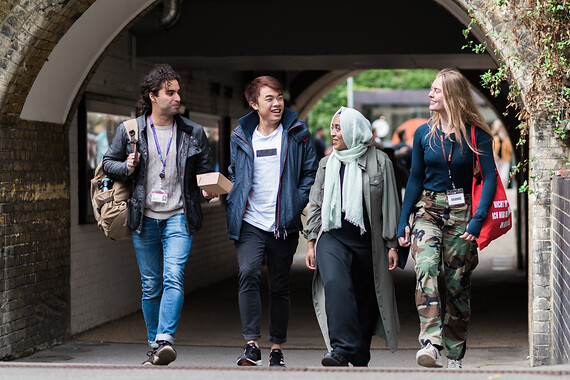 A diverse group of students walk together on campus