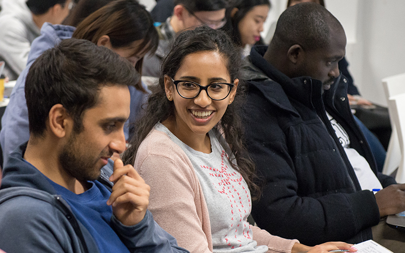 Three students engaging in a lecture