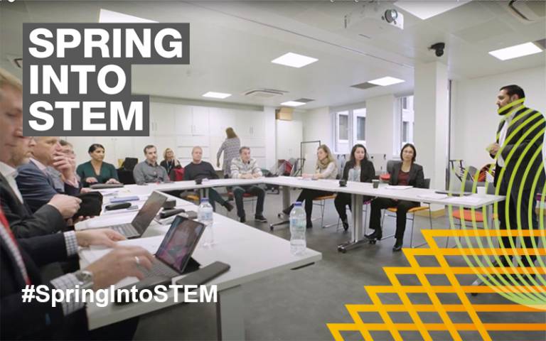 Dr Qasim Rafiq in a classroom with Spring into STEM Logo overlaid