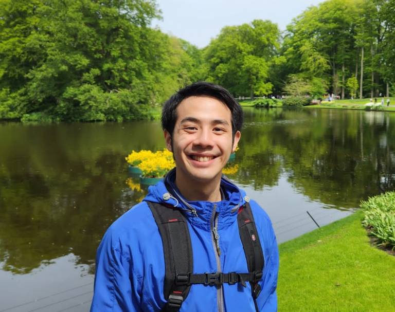 Dicky Lim, UCL alumni, in front of a lake