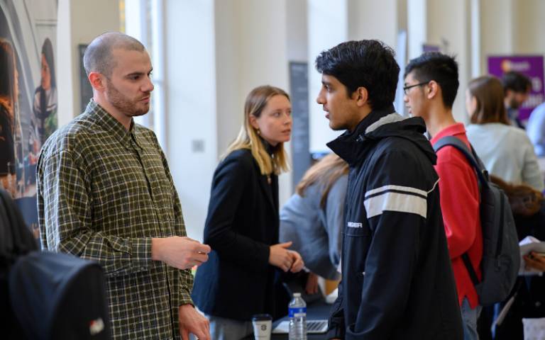 An employer speaking to a student at a Careers Fair