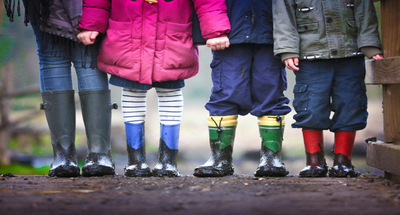 children standing on a muddy path