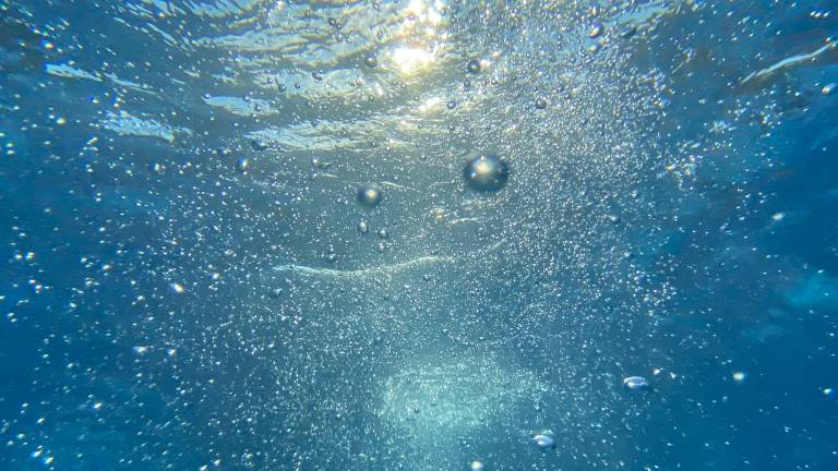 Underwater with bubbles and light piercing through