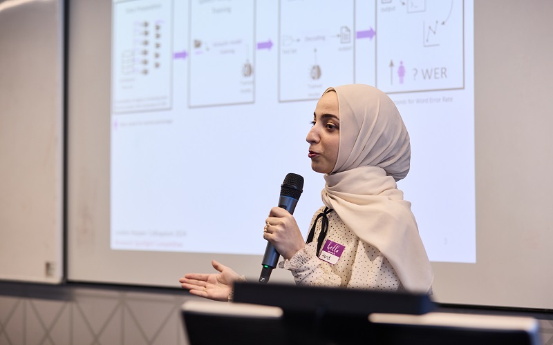 Women speaking into a mircophone at UCL London Hopper event