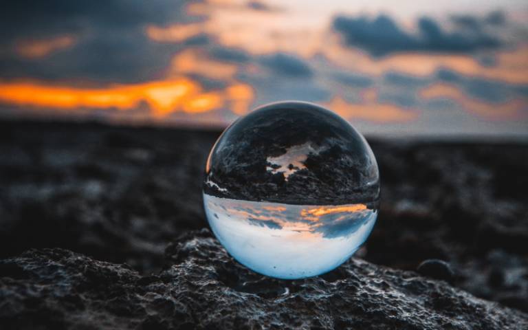 Small glass sphere on a rock