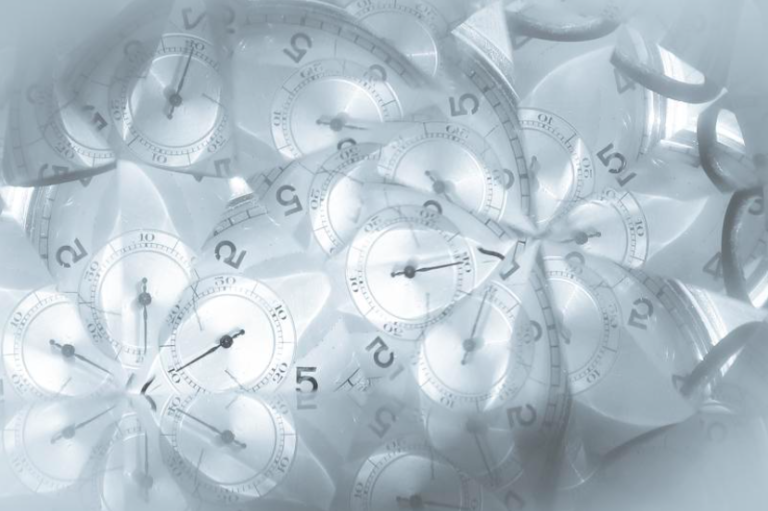 distorted clocks in grey tones on a white backdrop