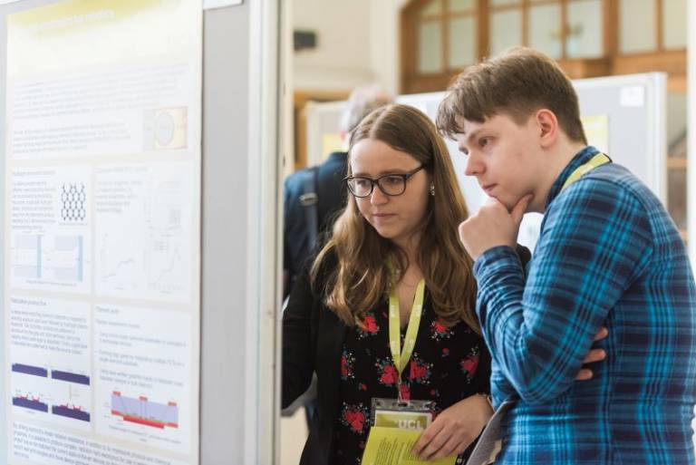 Image of EEE's PG students observing a poster 