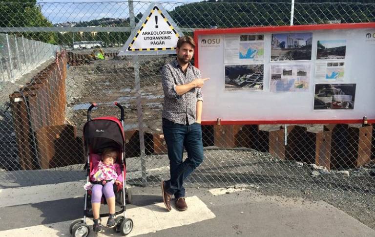 A photo of Tom Davies standing outside a building site