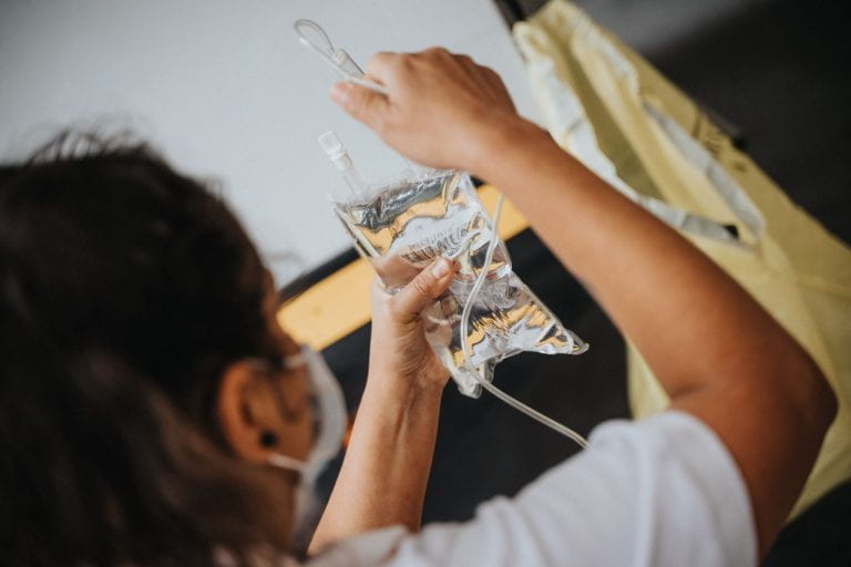 Healthcare worker photograph holding an IV drip