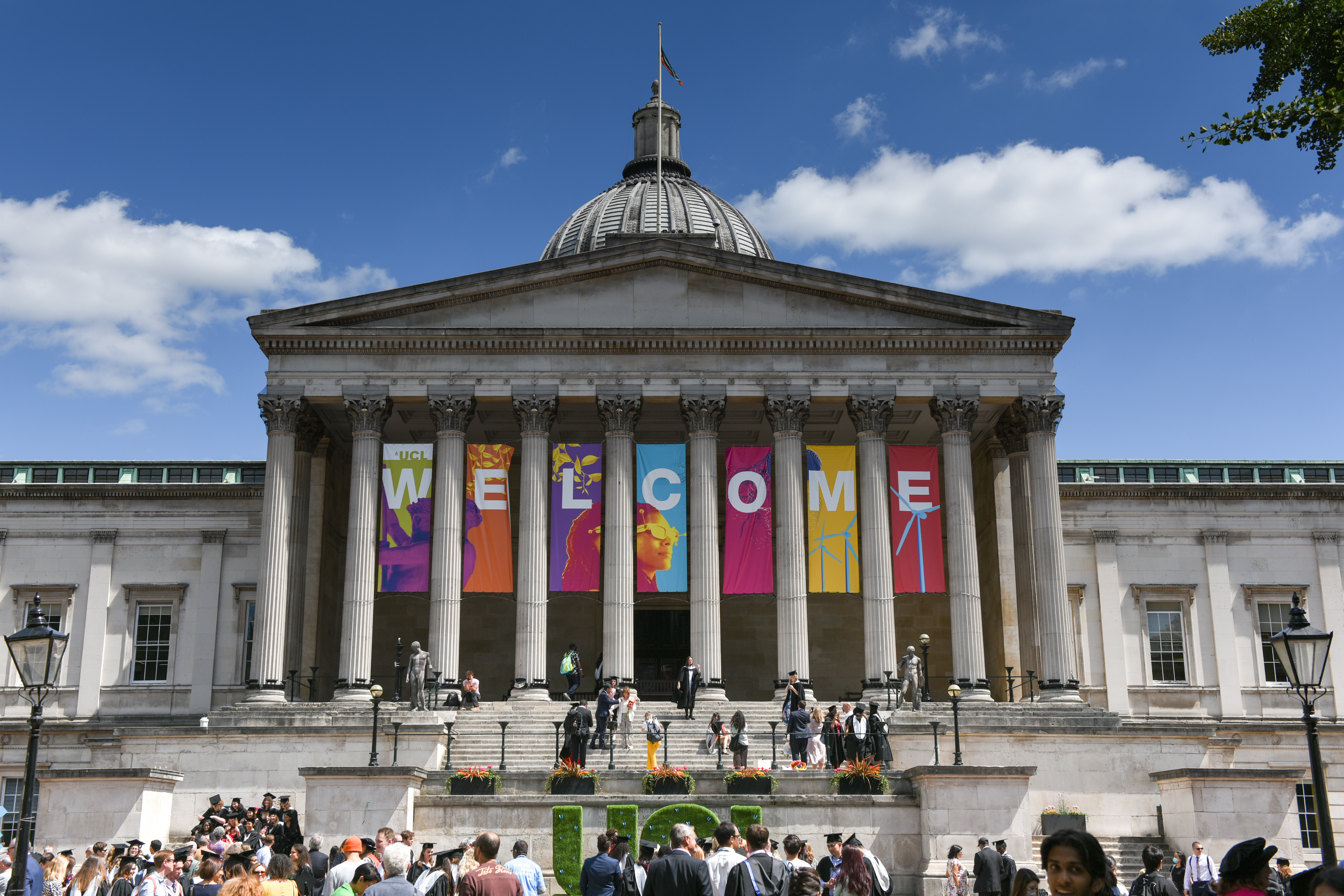 Front of the portico with welcome banners and students standing around