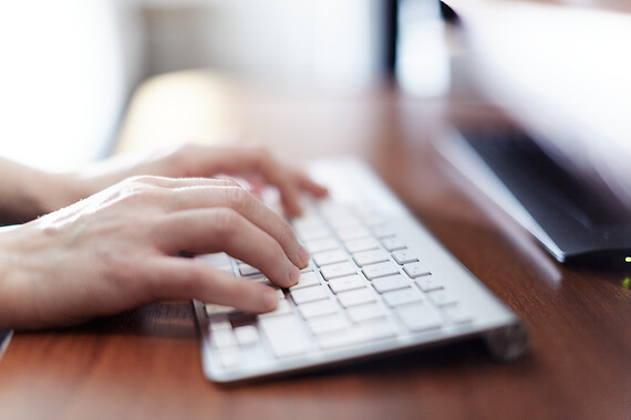 Hands typing on a keyboard