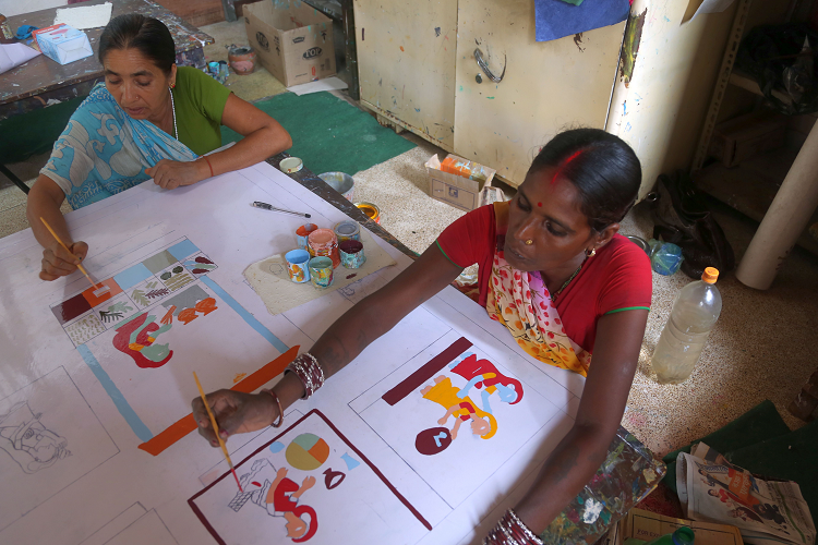 Two women painting pictures