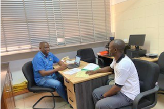 Dr. Stephen Muya talking with a META trial client