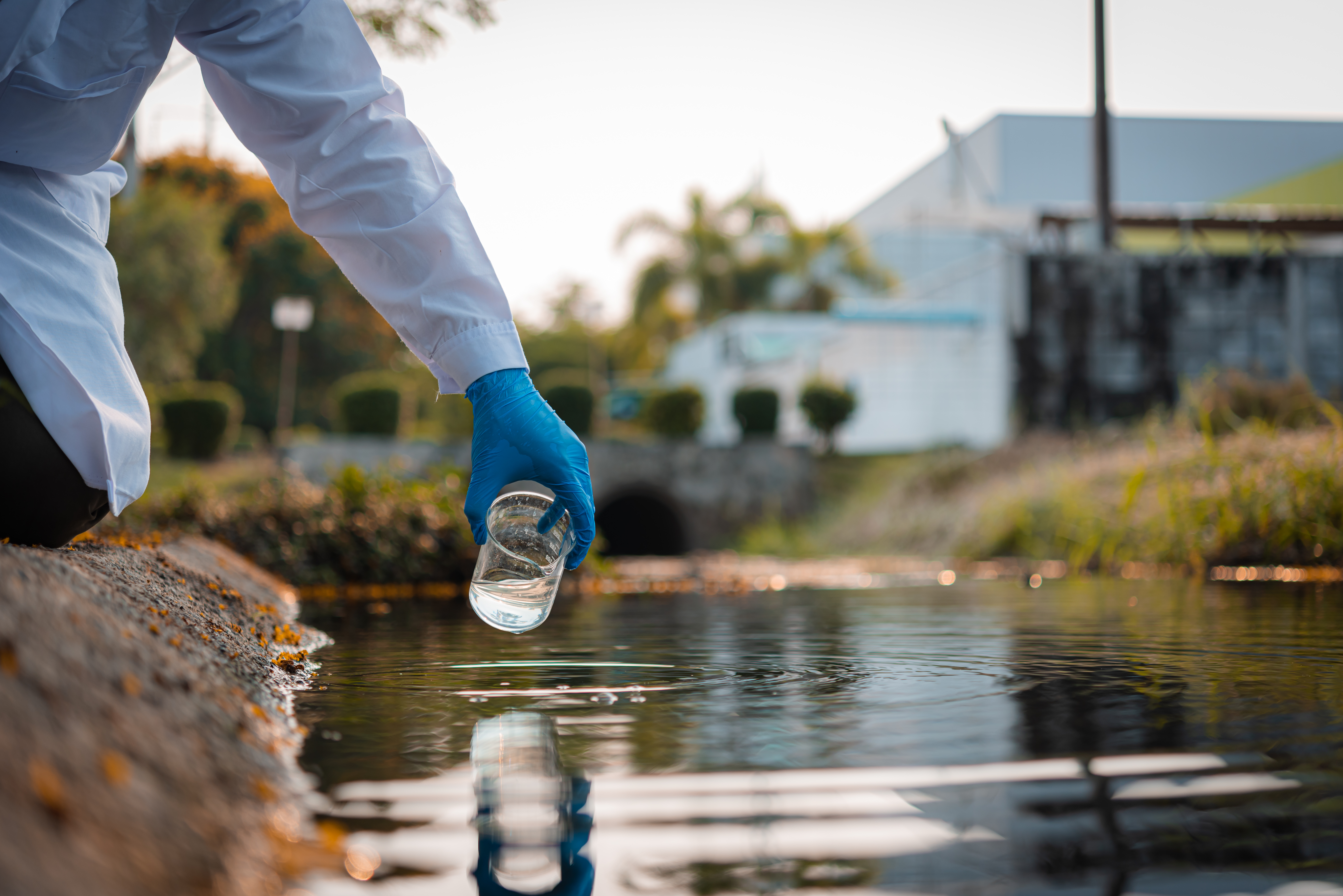 Image of scientist collecting water sample