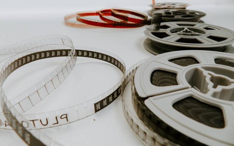 film reels unspooling on white table