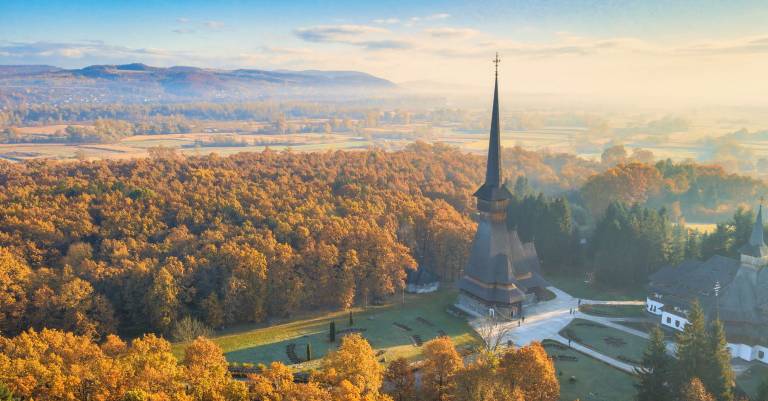 Aerial view of Romanian landscape with a church in the foreground