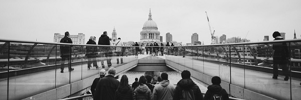 black and white photo of people crossing bridge from Tate Modern to St Pauls