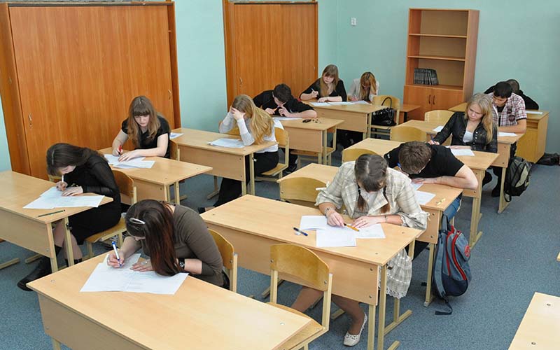 Classroom of students taking paper exams.