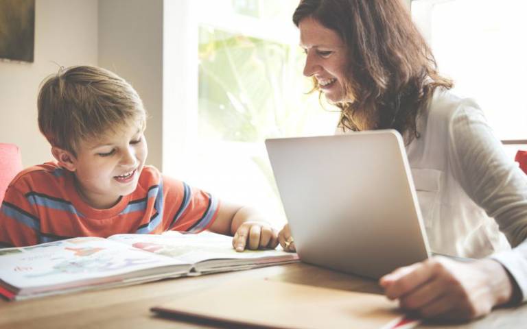 Child sitting and reading with parent. Image: Rawpixel.com via Shutterstock, courtesy of Dean Crow, CIE