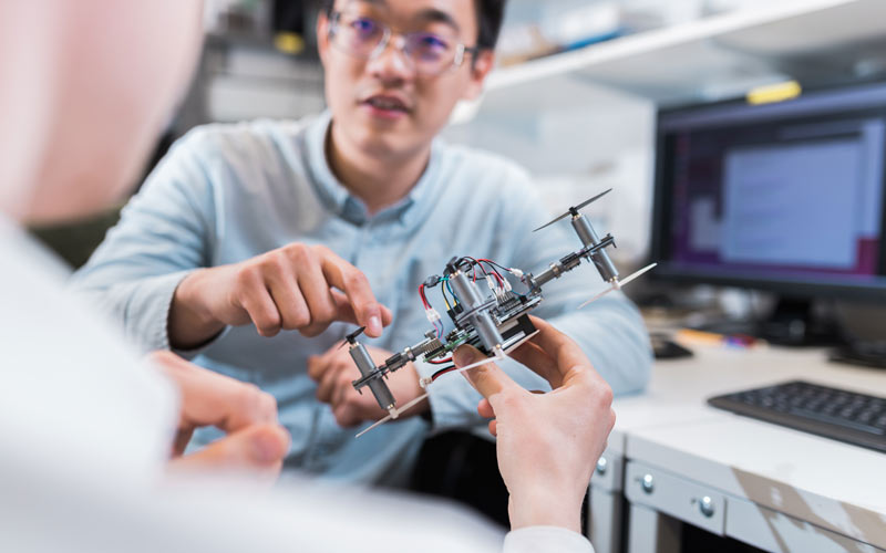 UCL Mechanical Engineering mini drone being discussed in power systems lab