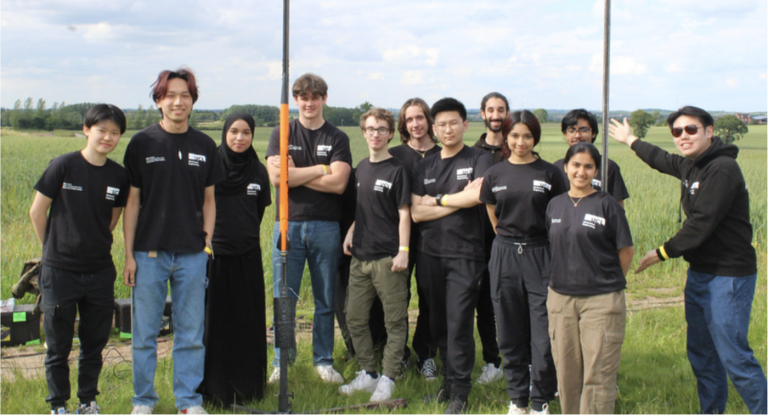 UCL’s Rocket team in a field celebrating their win