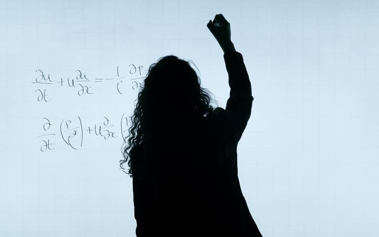 Silhouette of a Female aerospace engineer writes equations