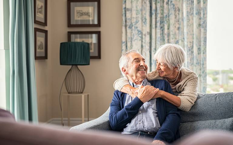 Older couple sitting together and smiling