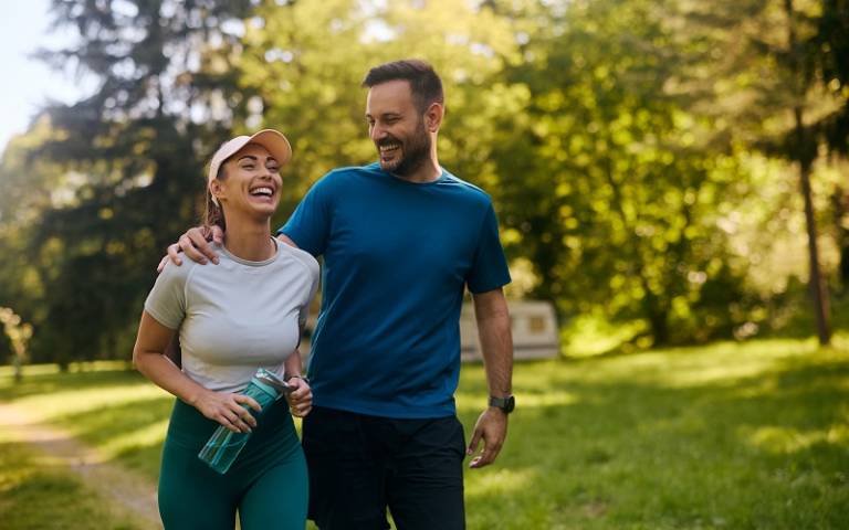 Cheerful couple exercising in nature