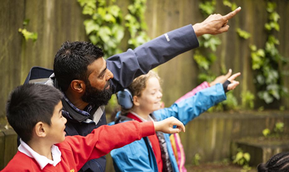 primary pupils and teacher outside