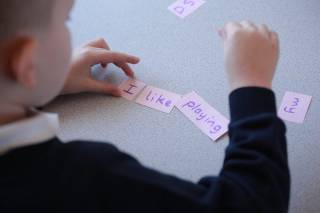 a boy is making a puzzle