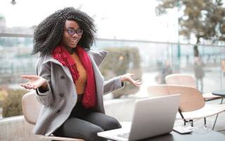 cheerful_surprised_woman_sitting_with_laptop