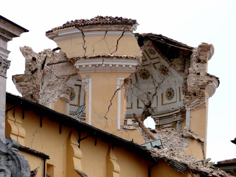 Partially destroyed tower with external cracks in remaining walls