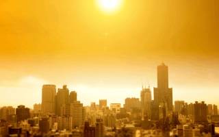 city skyline under hot yellow sun