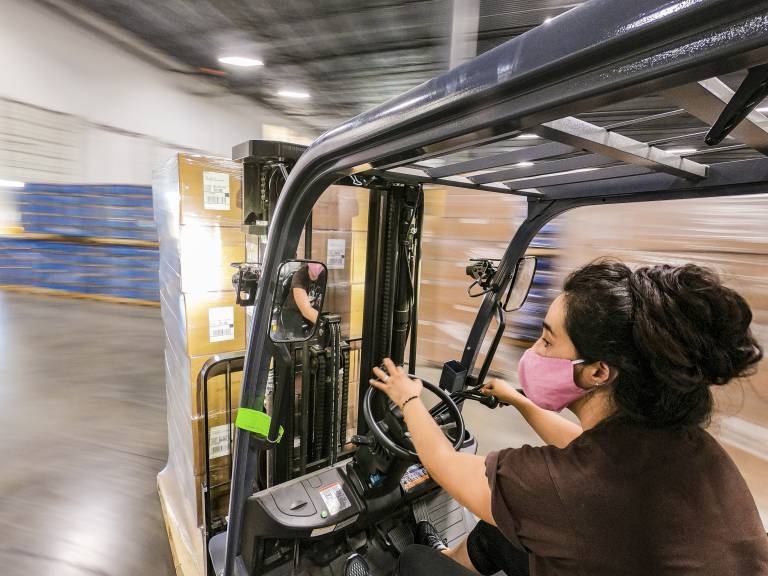 A woman operating fork lift truck