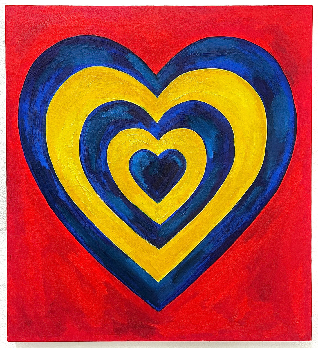 The image shows a painting of five concentric hearts in blue and yellow over a red background.