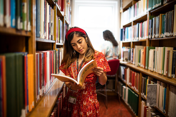 UCL Student reading at the library