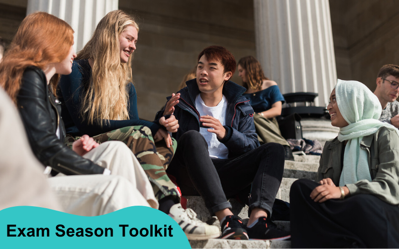 Group of students chatting on the Portico steps in the Main Quad