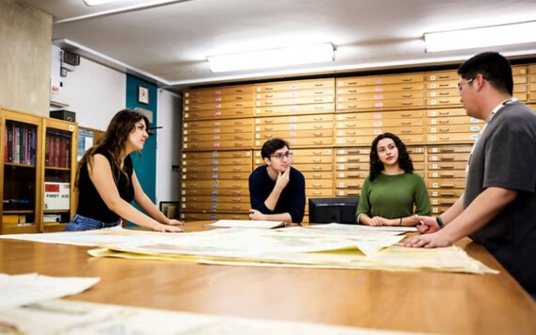 people around a table looking at documents.