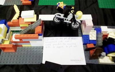 two lego models with a lego figure on a motorbike jumping in between