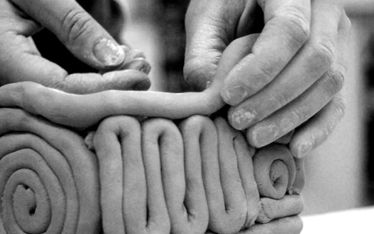 hands making coiled pottery