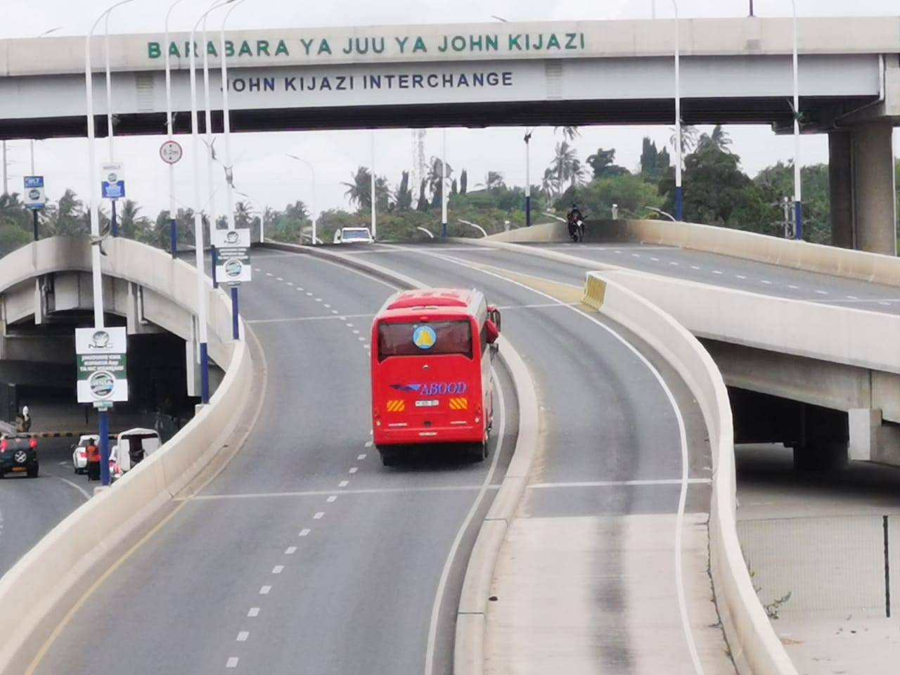 bus drives up on-ramp on new-looking road