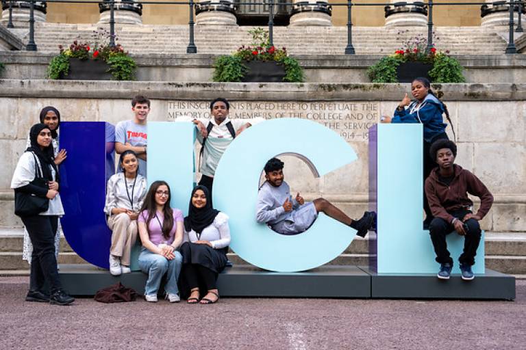 Summer School students gathered around the UCL letters on the Main Quad